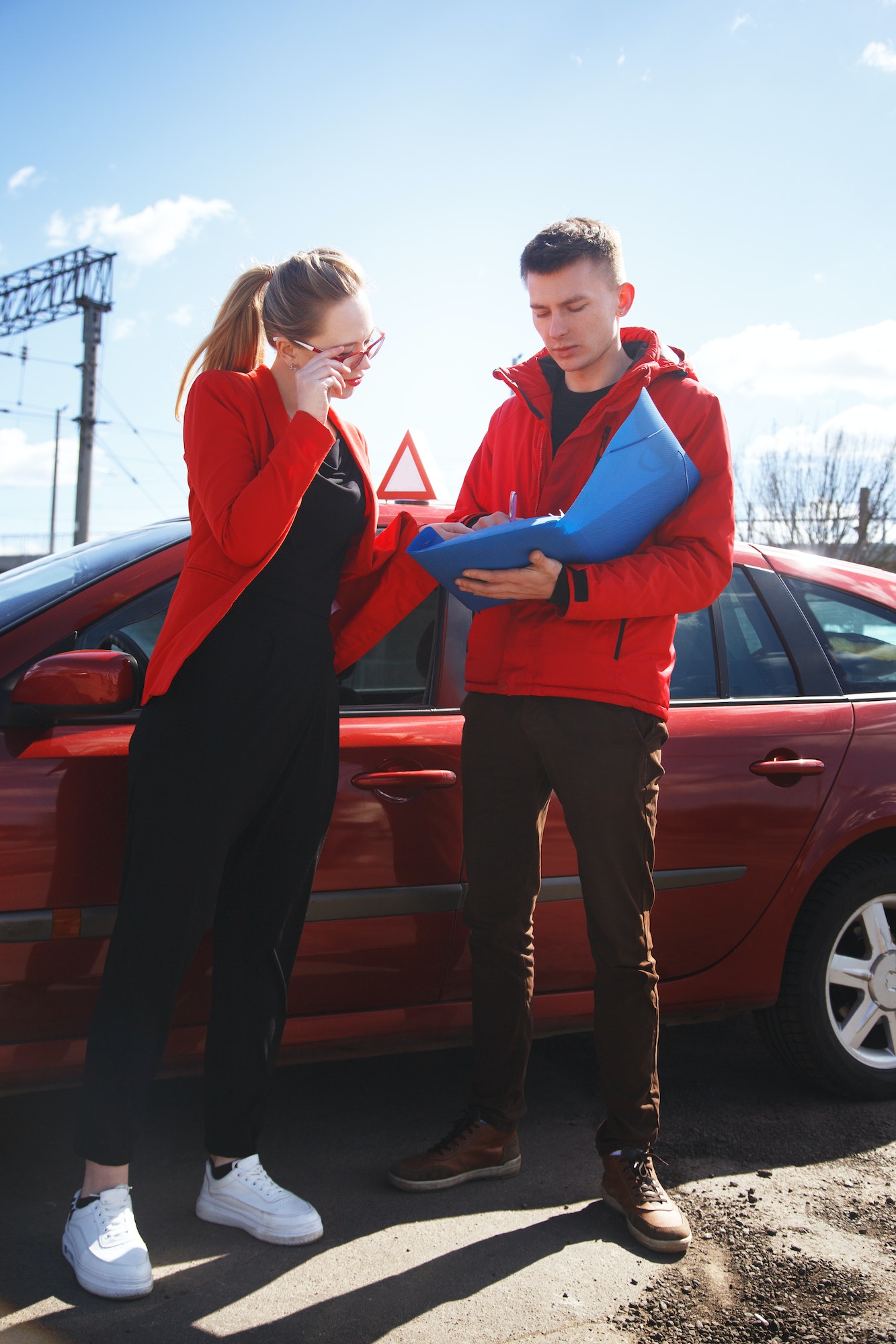 Driving instructor and woman student in examination car.